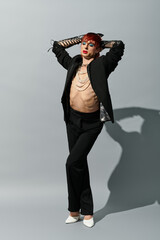 A stylish young man poses confidently, showcasing his bold fashion and charisma.