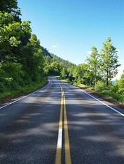 Fototapeta premium A stretch of asphalt road winding its way up a hillside, disappearing into the blue expanse of the sky, hillside, asphalt pavement, scenic drive