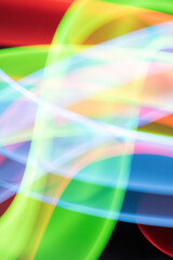 Neon Rainbow Light on Black Background Abstract Lines Swirls and Waves