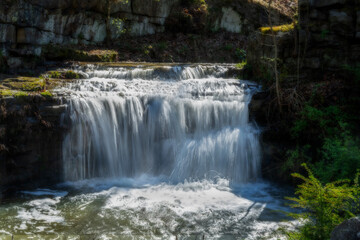 Small water flowing over rocks in a culvert