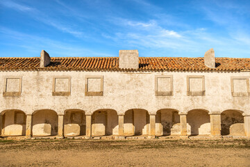 Fototapeta premium Colonnade Building at Santuário de Nossa Senhora do Cabo Espichel on a Sunny Day, Portugal. December 2024