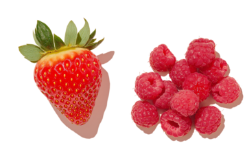 A single ripe strawberry with its green calyx intact, placed beside a small heap of raspberries, isolated on background.
