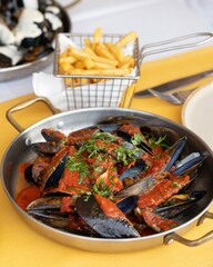 Mussels in Rich Tomato Sauce with French Fries