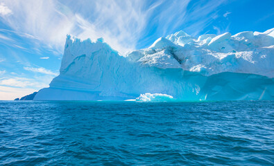 Melting icebergs by the coast of Greenland, on a beautiful summer day - Melting of a iceberg and pouring water into the sea - Greenland