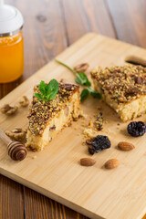 Sponge cake with prunes and nuts on wood
