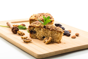 Ruddy sponge cake with prunes and nuts for tea, isolated on white background