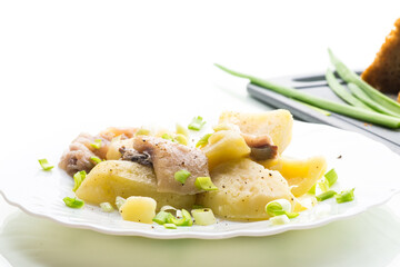 Traditional dinner - potatoes and herring, isolated on white background