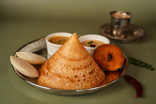Homemade Triangle Dosa served with chutney sambar idli and vada | South Indian vegetarian breakfast