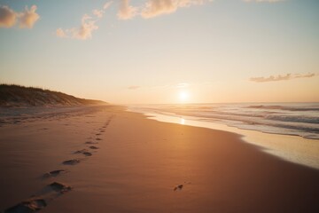 Obraz premium Path to Success - Inspirational Beach Scene with Footprints Leading to Glowing Horizon