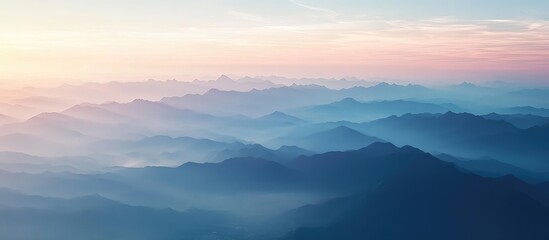 Obraz premium Airplane window perspective of mountain range at dawn with clear sky background