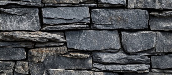 Obraz premium Textured Grey Stone Wall with Dark Black Concrete Elements, Panoramic Background Ideal for Copy Space and Creative Design, Flat Lay Perspective.