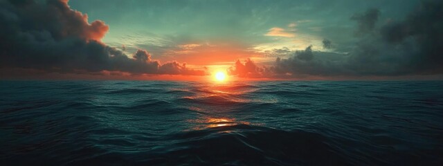 Sunset over calm ocean waters with dramatic clouds and reflection in the water Copy Space