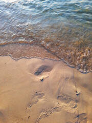 Background photo of waves on a sand beach