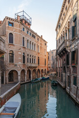 Quiet Venetian Canal with Boats and Historic Buildings