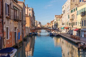 Vibrant Venetian Canal Scene with Boats and Colorful Buildings