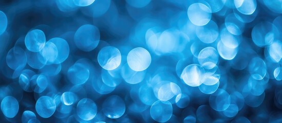 Blue bokeh background with soft circular lights and gradients providing copy space for text placement