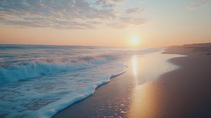 Fototapeta premium Waves gently rolling on a quiet beach during sunrise, capturing tides and reflections on wet sand.