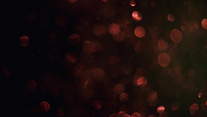 Holiday abstract bokeh on black background. Festive sparkling gold dust. Holiday concept