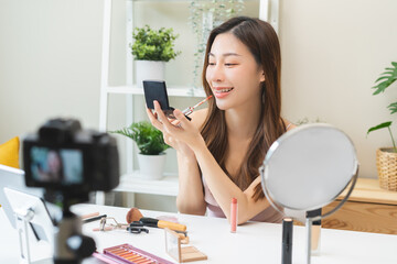 Beauty cosmetic, cute asian young woman, girl make up face by applying lip gloss, pink or nude...