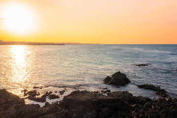 Sunset sky over a rocky beach