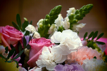 bouquet of flowers close up . pink roses, purple and white carnations, lilies . copy space . wedding bouquet on dark background . mother's day . many flowers
