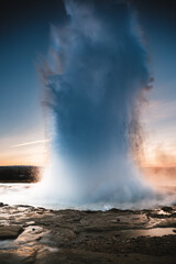 Strokkur Geysir eruption at sunset in south Iceland, Haukadalur valley
