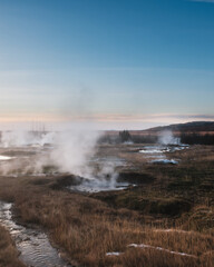 Geothermal steam vents in Haukadalur valley, south Iceland, at dawn.