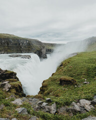 Majestic view of Gullfoss waterfall surrounded by lush greenery in south Iceland...