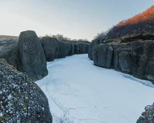Frozen canyon of Brúarhlöð in south Iceland with rugged cliffs and winter light...