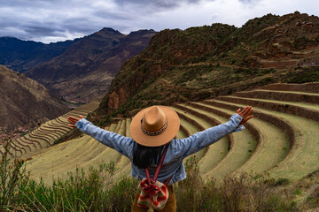 Latin tourist looking at the terraces of Pisac, Pisac archaeological complex in Cusco