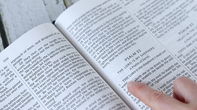 Person is reading holy bible book. Christian Scripture study, biblical concept.