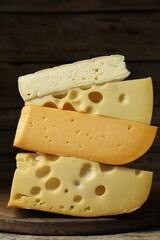 Stacked different types of cheese on table