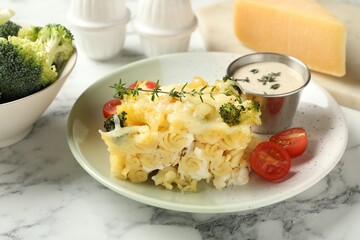 Tasty pasta casserole with cheese and broccoli served on white marble table, closeup
