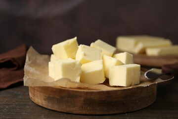 Pieces of fresh butter on wooden table, closeup