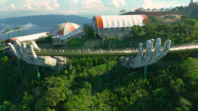 Aerial view of the Golden Bridge is lifted by two giant hands in the tourist resort on Ba Na Hill in Da Nang, Vietnam.