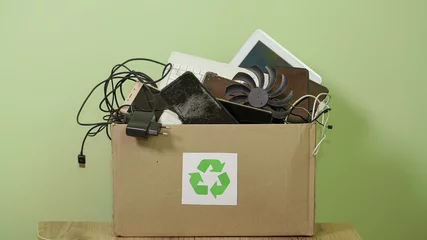 Paper Box with Sing Recycling, Old Electronic waste, phones, tablets, gadget devices for recycling. Planned Obsolescence, e-waste, electronic waste for Reuse Recycle Concept © liliya