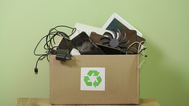 Paper Box with Sing Recycling, Old Electronic waste, phones, tablets, gadget devices for recycling. Planned Obsolescence, e-waste, electronic waste for Reuse Recycle Concept