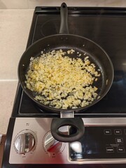 Sauteing onions in a modern kitchen while preparing for a delicious meal with a cozy atmosphere