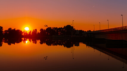 Fototapeta premium Sunset with reflections near Plattling, Isar, Bavaria, Germany