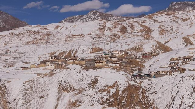 kibber village situated on snow covered spiti valley with blue sky