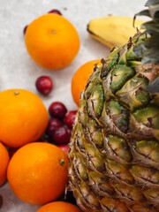 Vibrant display of tropical fruits arranged artfully on a neutral surface showcasing nature's bounty in a cheerful and inviting manner