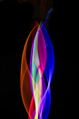 Neon Rainbow Light on Black Background Abstract Lines Swirls and Waves