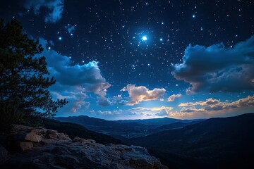 Naklejka premium A captivating night sky filled with stars and clouds above a tranquil mountain landscape, with rocky foreground and distant hills