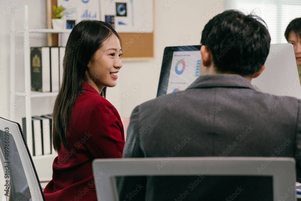Poster two asian businesspeople are collaborating on a project, analyzing financial charts displayed on a c
