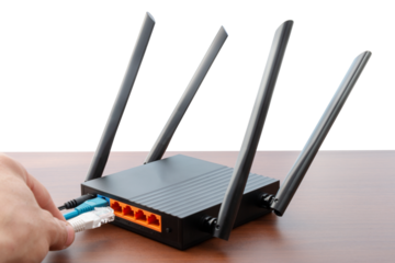 hand connecting cable to Wireless Wi-Fi router on wooden table, cut out, isolated, with copy space. Wireless connection concept,