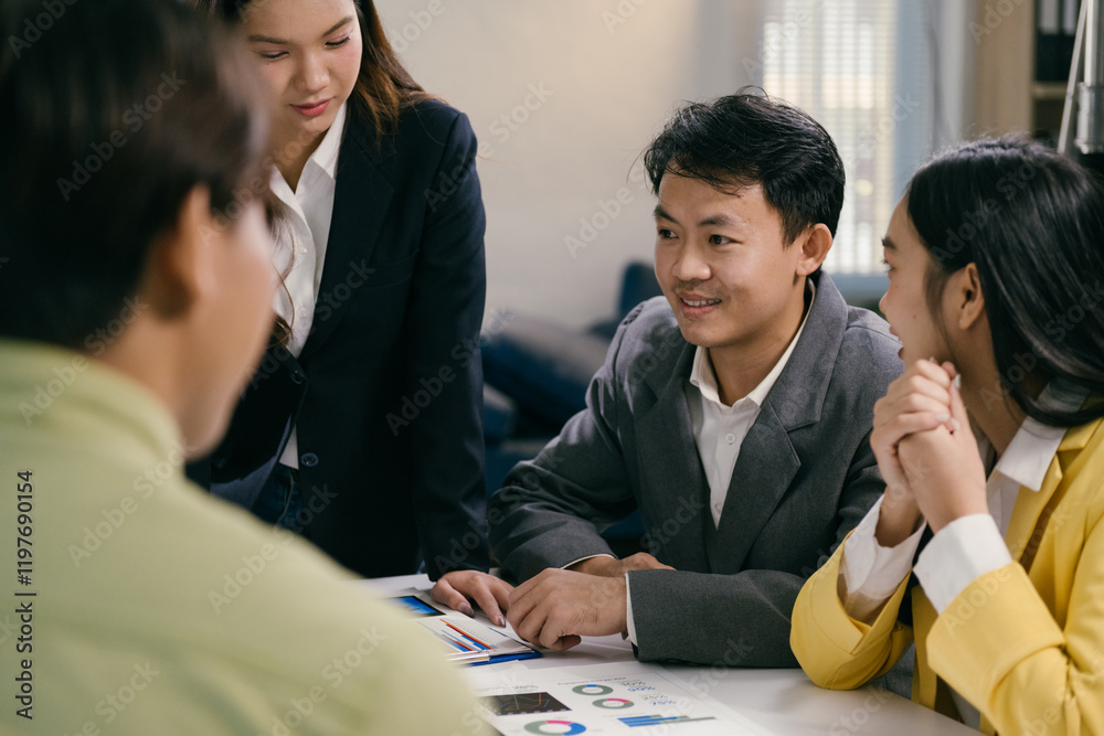Poster four asian businesspeople are having a meeting in a modern office, analyzing charts and discussing s