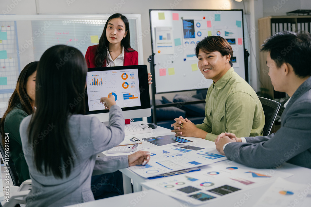 Aufkleber Business colleagues are collaborating on a project, analyzing charts and graphs displayed on a computer screen during a productive office meeting