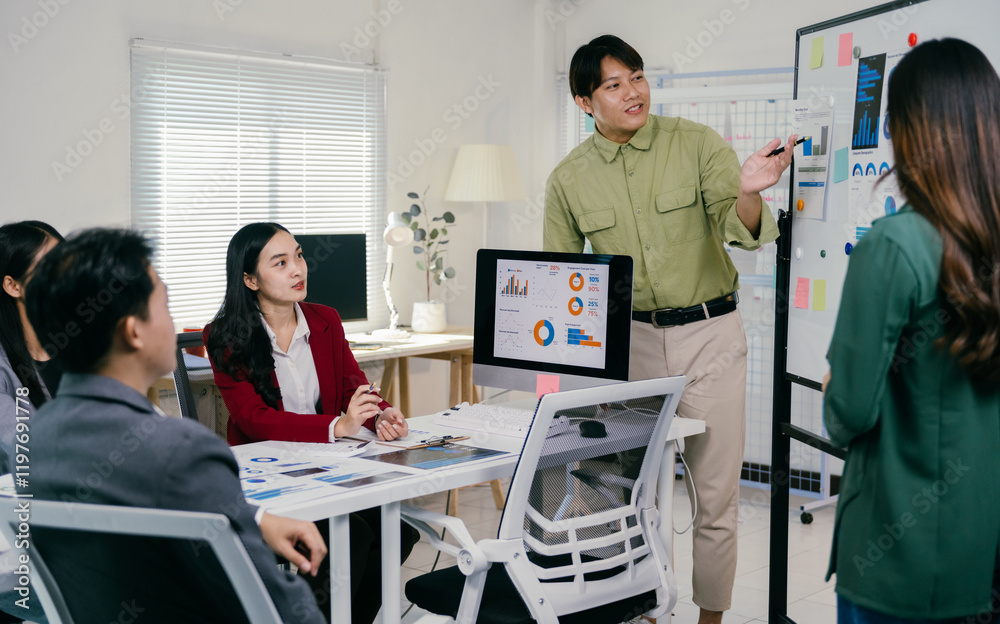 Poster diverse group of asian professionals engaging in a productive office meeting, analyzing charts and g