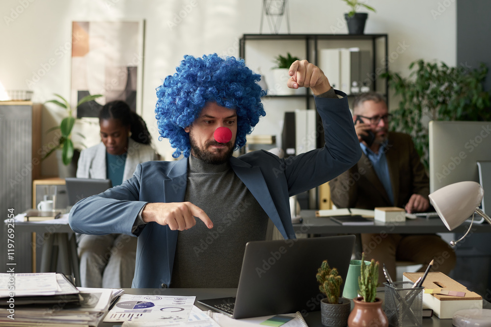 Aufkleber young male analyst in formalwear and clown wig sitting by workplace in front of laptop and pressing 