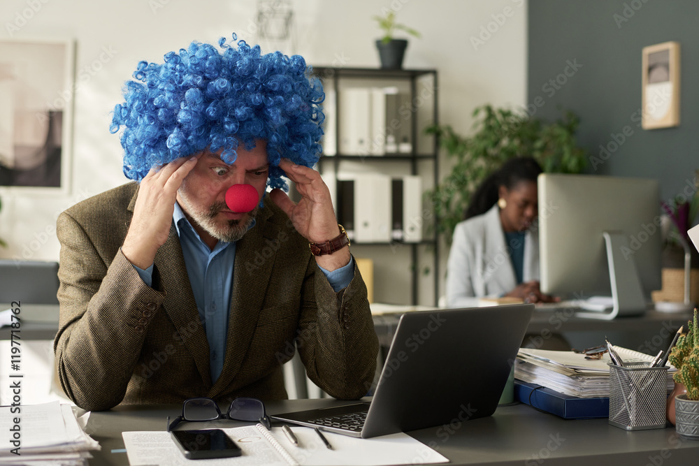 Poster tense or surprised clown boss touching head and looking at laptop screen while working over new busi